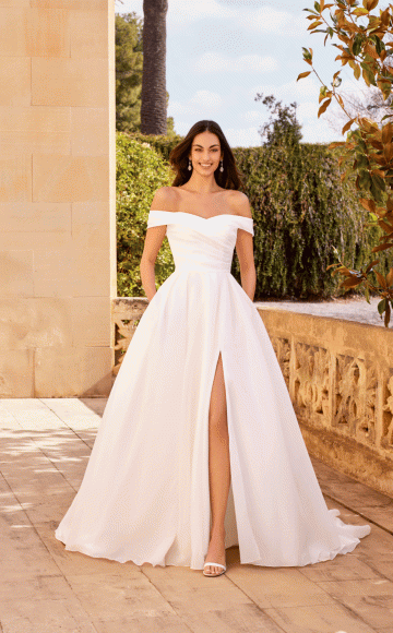 Justin Alexander 20005, Off the shoulder Organza wedding dress with full skirt & leg slit - Classic & simple wedding dress collection at Blessings of Brighton, Loyal Parade, Mill Rise, Westdene, Brighton. BN1 5GG