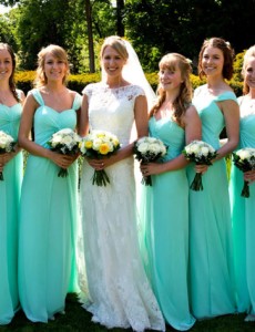 Julie wore a lace sheath wedding dress by Essense of Australia. Her Ice Mint chiffon bridesmaid dresses are by Venus